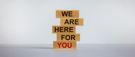 Wooden blocks with text 'we are here for you'. Beautiful white background, copy space. Business concept. - obrazy, fototapety, plakaty
