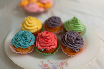 Delicious homemade cupcakes for a birthday celebrations - colored whip cream