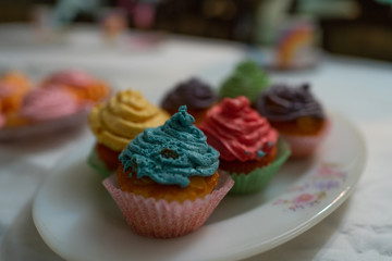 Delicious homemade cupcakes for a birthday celebrations - colored whip cream