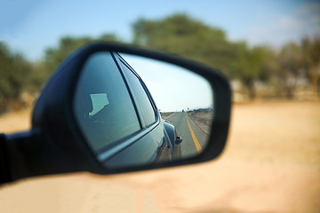 Road view through the car mirror