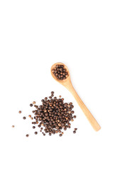 Wooden spoon and black pepper isolated