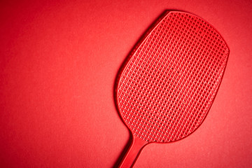 red isolated plastic fly trap on intense colored background