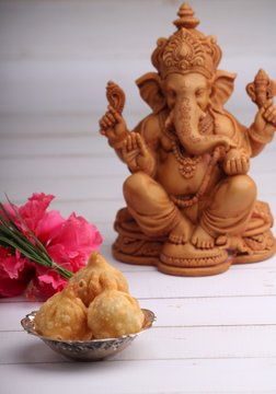 Indian Food: Idol of lord Ganesha with modak Maharashtra Sweet Dish, greeting card. Ganesh chaturthi
