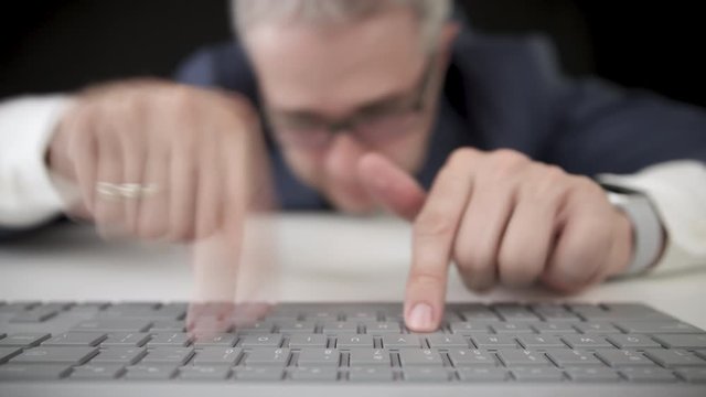 Funny tired businessman typing fast on the computer keyboard and falls asleep, time lapse video