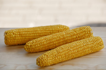 Close up corn on wooden table.