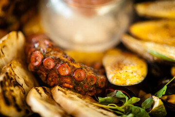 Seafood platter for 2-4 persons. Octopus, blue mussels, cooked green mussels, grilled tiger prawns, tuna tartare. Delicious seafood closeup served on a table for lunch in modern gourmet restaurant