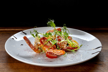 Prawn salad. Healthy Shrimp Salad with mixed greens and tomatoes, the food glows in a beautiful backlight.
