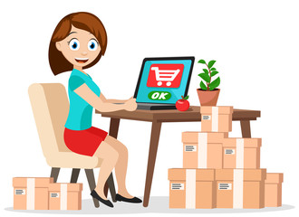 A girl sits at a table with a laptop and orders goods with delivery. E-commerce