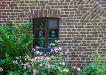 brick wall with window and flower