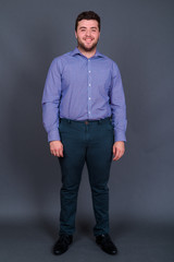 Obraz premium Portrait of happy young handsome overweight bearded businessman