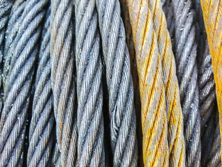 Detail of electrical power cable on the reel. Roll of metal wire of silver color.