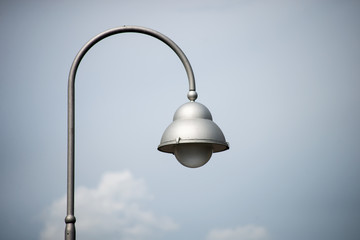 Closeup of modern street lamp on stormy sky background