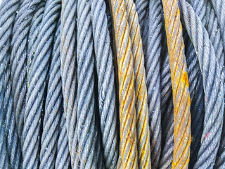 Detail of electrical power cable on the reel. Roll of metal wire of silver color.