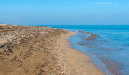 Sea waves on an empty beach, selective focus.