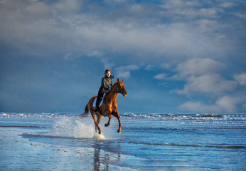 Fototapeta na wymiar Riding on the Beach