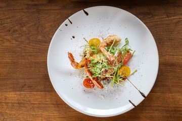 Prawn salad. Healthy Shrimp Salad with mixed greens and tomatoes, the food glows in a beautiful backlight.