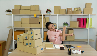 Young Asian worker woman stretch arms after working for a long time in the office.