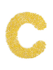 Letter C of the English alphabet made from millet on an isolated background.