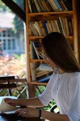 Profile portrait of a teenage girl reading a book