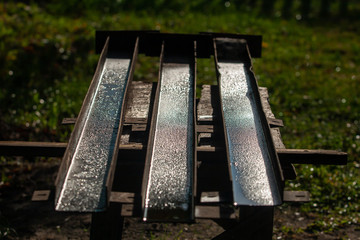 Fototapeta premium three wet rusty channels on a wooden workbench 