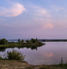 Fototapeta na wymiar Evening dusk on summer valley lake. Natural seasonal, weather, countryside beauty concept and background scene.