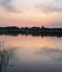 Sunset on summer valley lake. Natural seasonal, weather, countryside beauty concept and background scene.