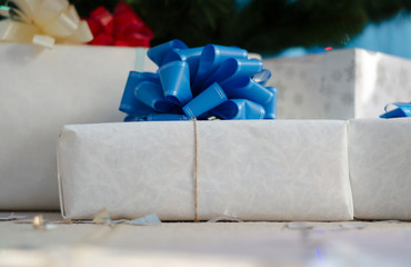 New Year, Christmas gifts in white paper with a blue bow. Christmas Holidays. New Year card