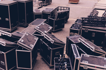 Boxes stage equipment for a concert on wood and old brick