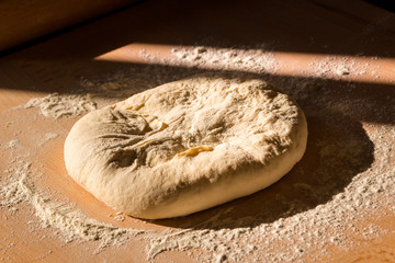 Pizza dough on a wooden board