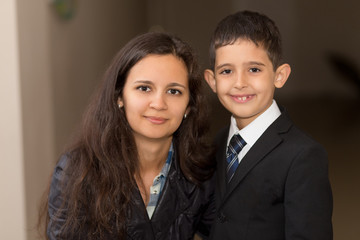 Happy cute clever boy in black suit with mother. Child is ready to school. First time to school. Back to school. 