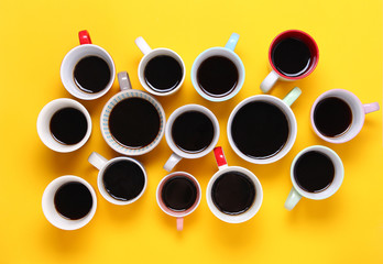 Many different cups of coffee on yellow background. Top view,flat lay,copy space.