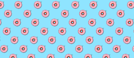 Seamless pattern with Christmas tree toy donut on blue. Holiday season concept, place for text