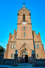 Fototapeta na wymiar historic, Gothic red brick church with belfry in the city of Skwierzyna