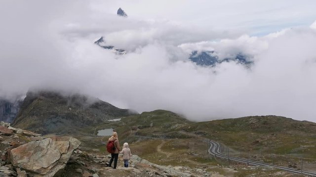 A person standing in front of a Matterhorn mountain , Switzerland Alps 