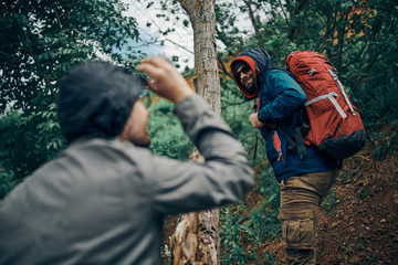 Two best friends climbing the hill on a camping trip.