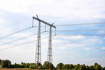 High-voltage tower against the sky with stretched wires.