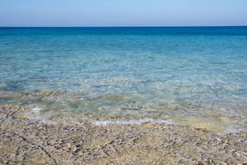 Sea with turquoise clear blue water and blue sky with copy space.