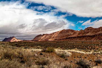 Dry grasslands and rugged mountains with thick clouds, AZ, USA