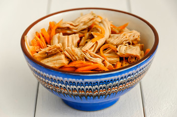Spicy Chinese or Korean Yuba (tofu bamboo) and carrots salad. Food product made from soybeans. Selective focus.
