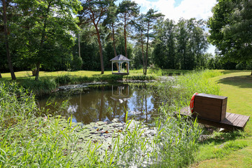 Romantic landscape in Estonia in front of a pond 