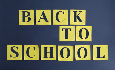 Yellow square notes are glued on a black background. The words 