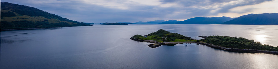 Fototapeta na wymiar Aerial view of the sound of shuna and shuna island on the west coast of the argyll region of the highlands of Scotland during a summer storm showing a salmon fish farm 
