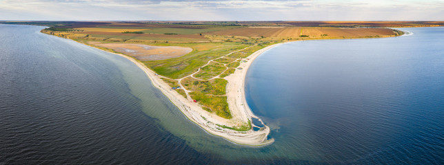 aerial panoramic view to the lake coast with narrow shallow with copy space © sergejson