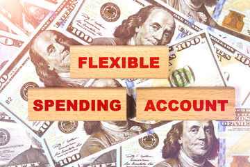 Against the background of dollar bills, the text is written on wooden blocks - flexible spending account