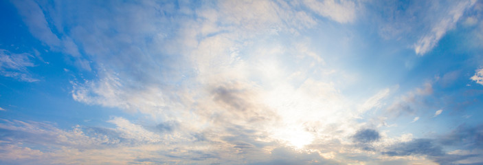 Blue sky clouds background. Beautiful landscape with clouds and orange sun on skysky