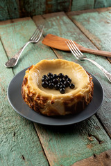 Homemade forest bluebery cheesecake on the old painted wood with old forks and wooden spatula