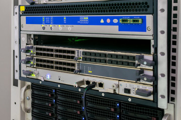Server equipment is configured in a modern data center. Computer hardware works in the server room. The technical platform of the Internet provider.