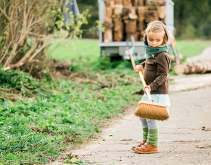 Toddler girl with broom