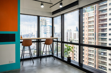 Desk with chairs at corner in modern office on business district