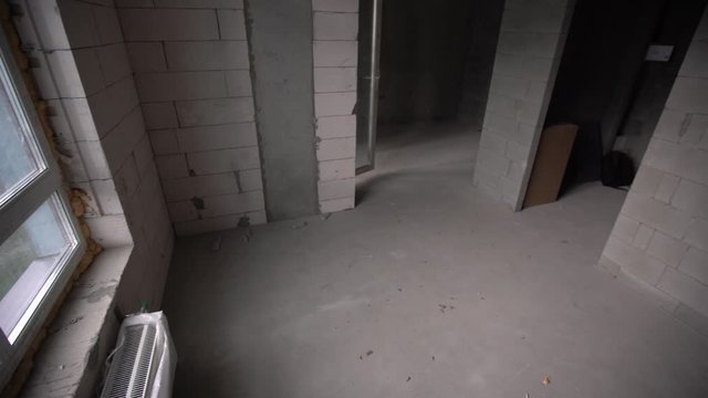 Small apartment without repair in a new building. A room in an unfinished house. Walls of foam block and concrete floor in a tiny apartment.